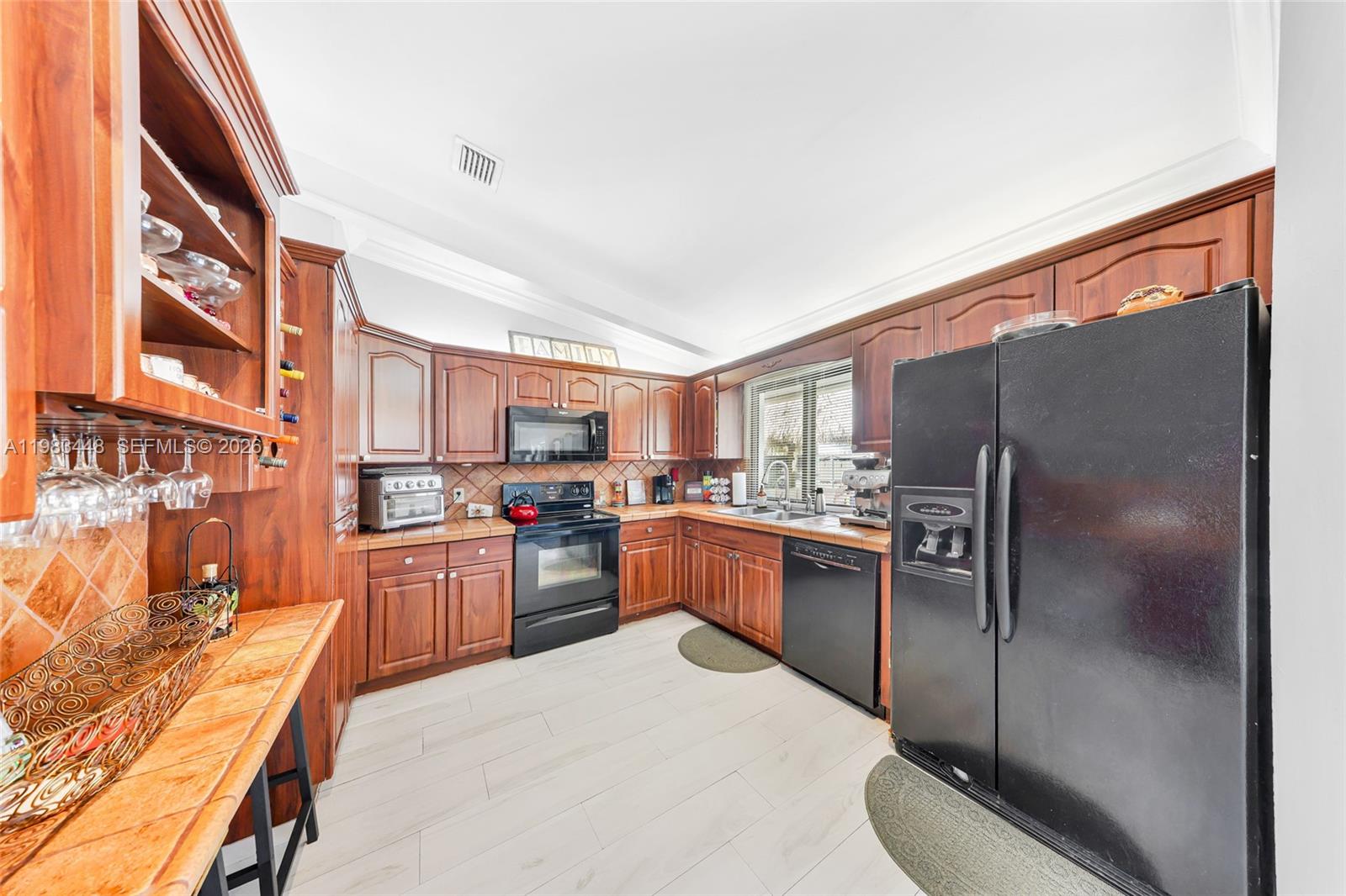 13951 Southwest 109th Street Miami, FL 33186 - Photo 11 of 34 a kitchen with stainless steel appliances granite countertop a refrigerator a stove and a sink with cabinets