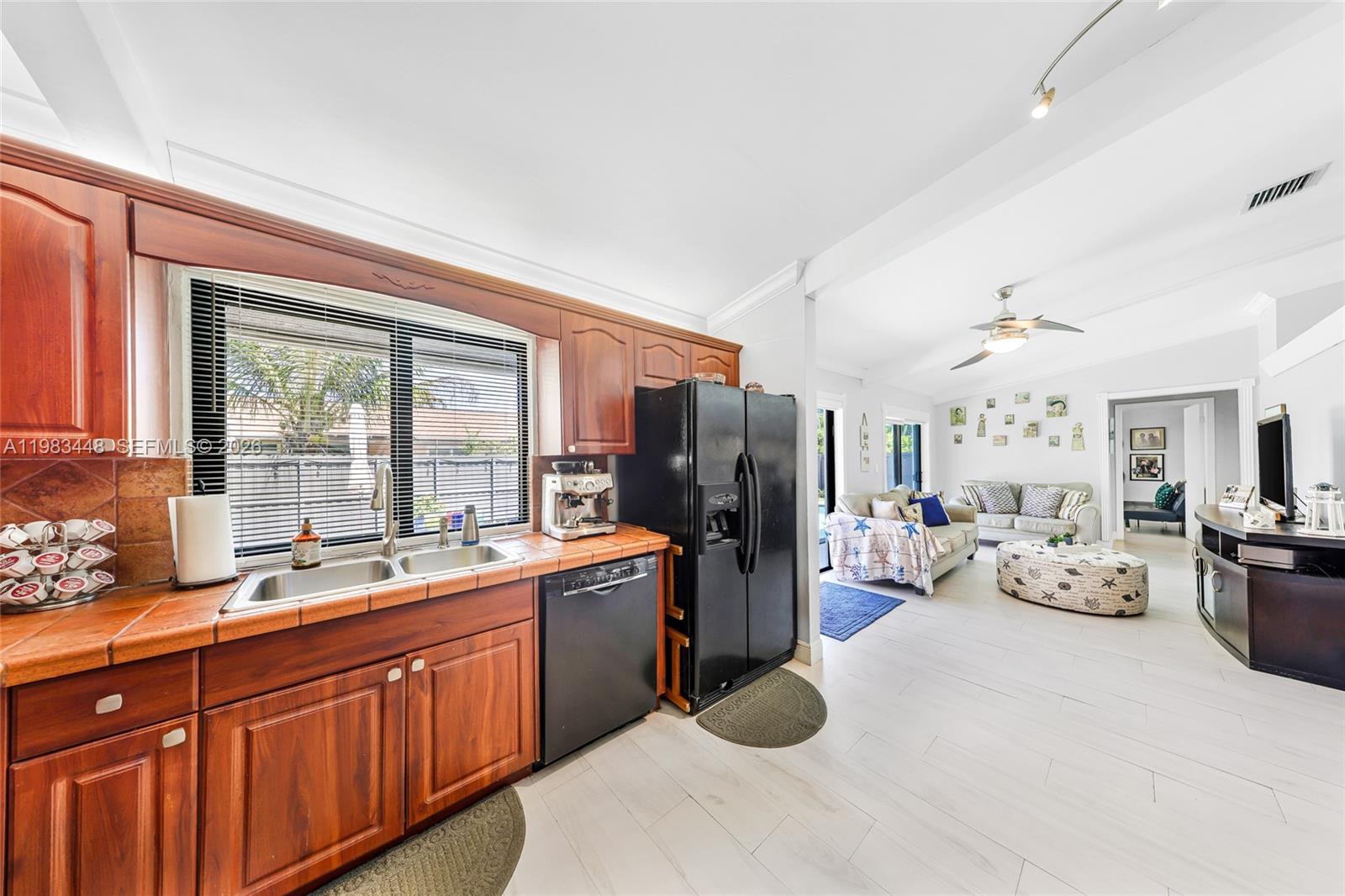 13951 Southwest 109th Street Miami, FL 33186 - Photo 12 of 34 a large white kitchen with a large window