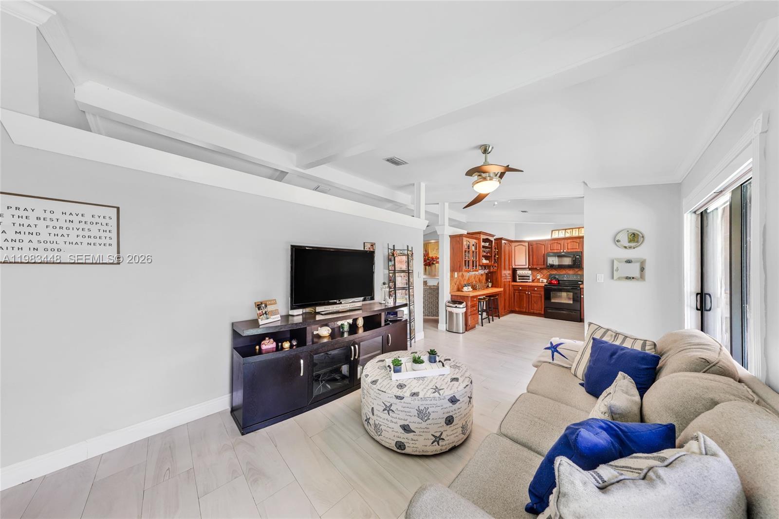 13951 Southwest 109th Street Miami, FL 33186 - Photo 13 of 34 a living room with furniture and a flat screen tv