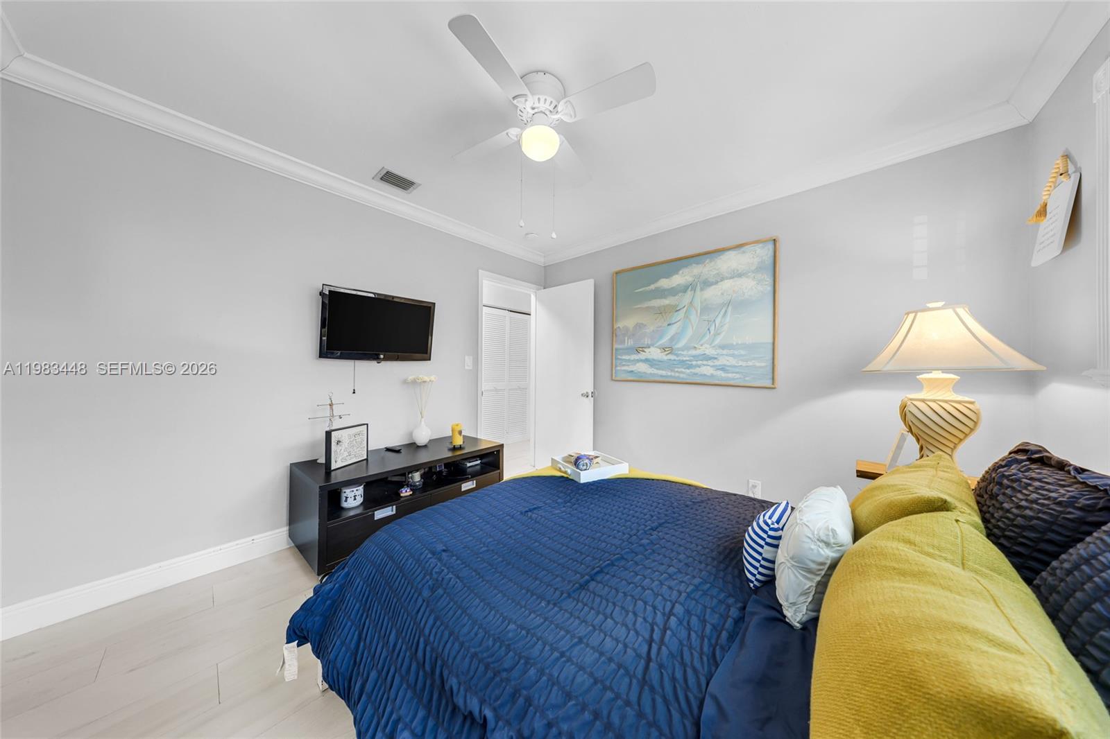 13951 Southwest 109th Street Miami, FL 33186 - Photo 18 of 34 a bedroom with a bed and a flat screen tv