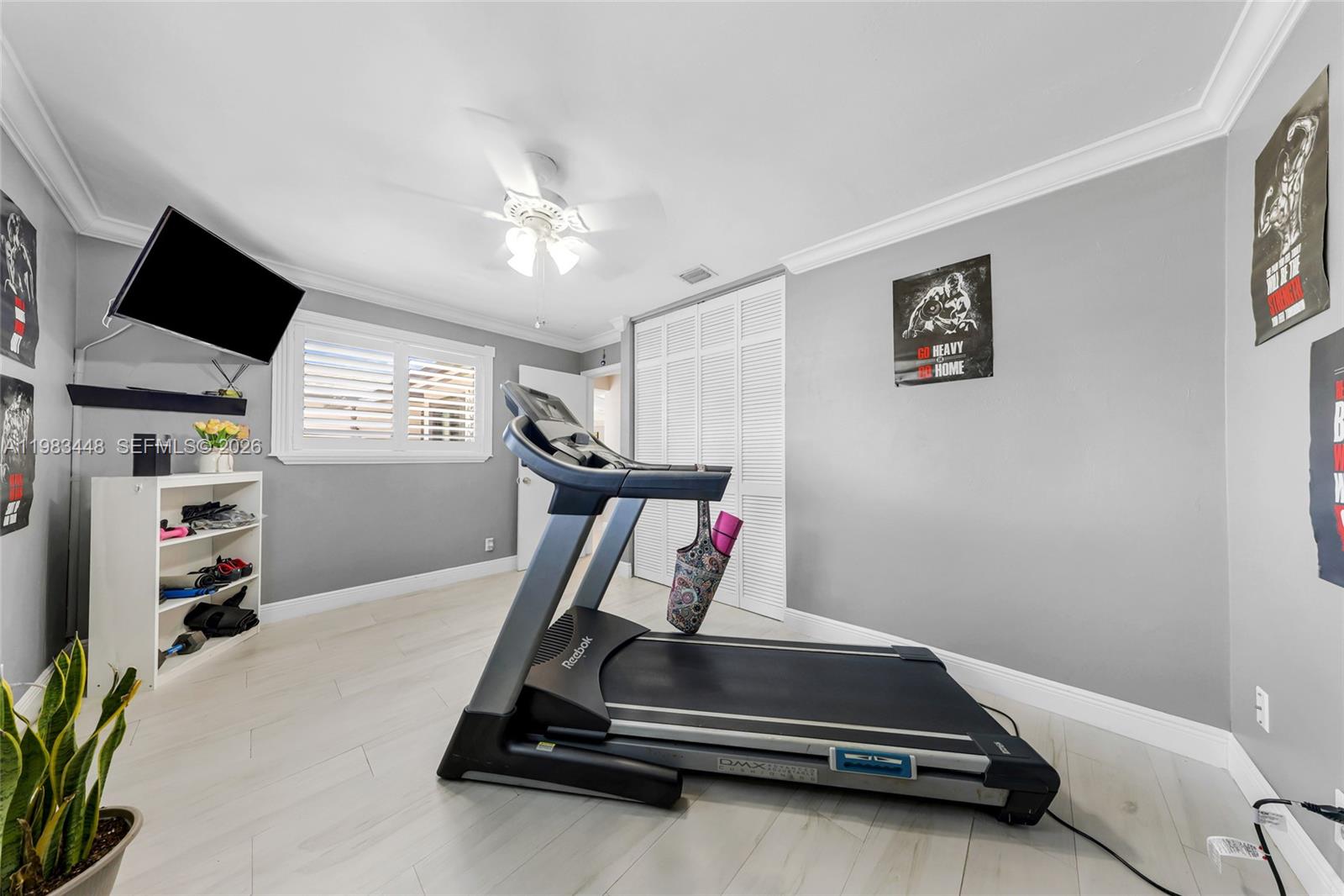 13951 Southwest 109th Street Miami, FL 33186 - Photo 20 of 34 a room with gym equipment and a flat screen tv
