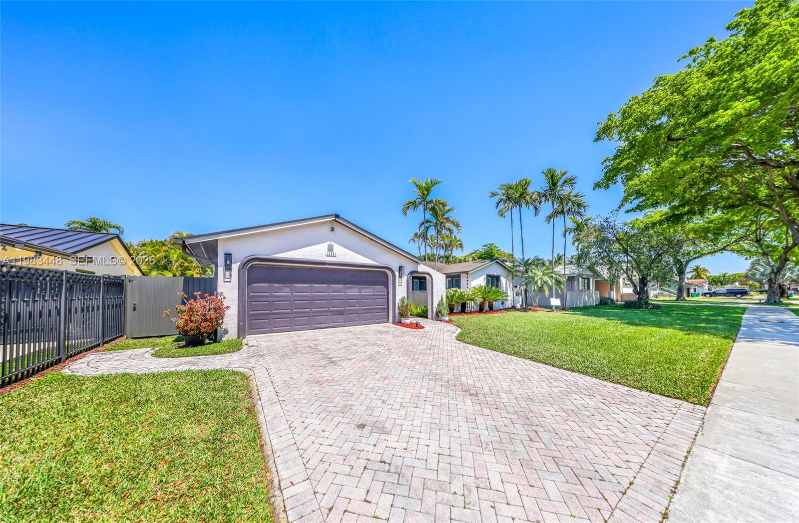 13951 Southwest 109th Street Miami, FL 33186 - Photo 2 of 34 a front view of a house with a yard and garage