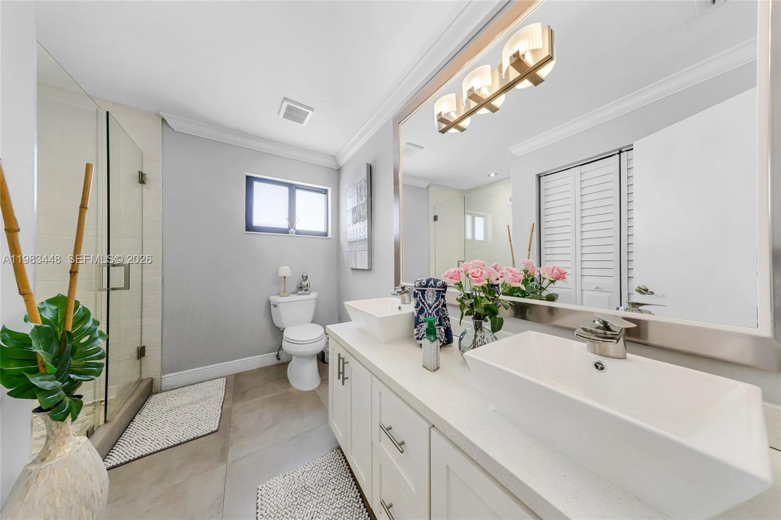 13951 Southwest 109th Street Miami, FL 33186 - Photo 24 of 34 a bathroom with a sink a toilet and a mirror