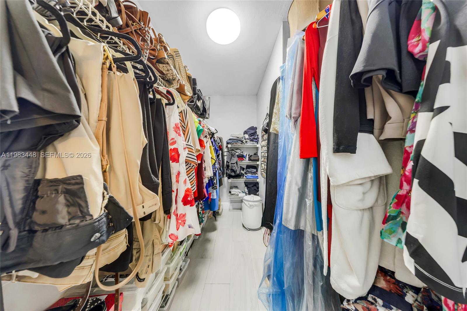 13951 Southwest 109th Street Miami, FL 33186 - Photo 26 of 34 a view of walk in closet with clothes