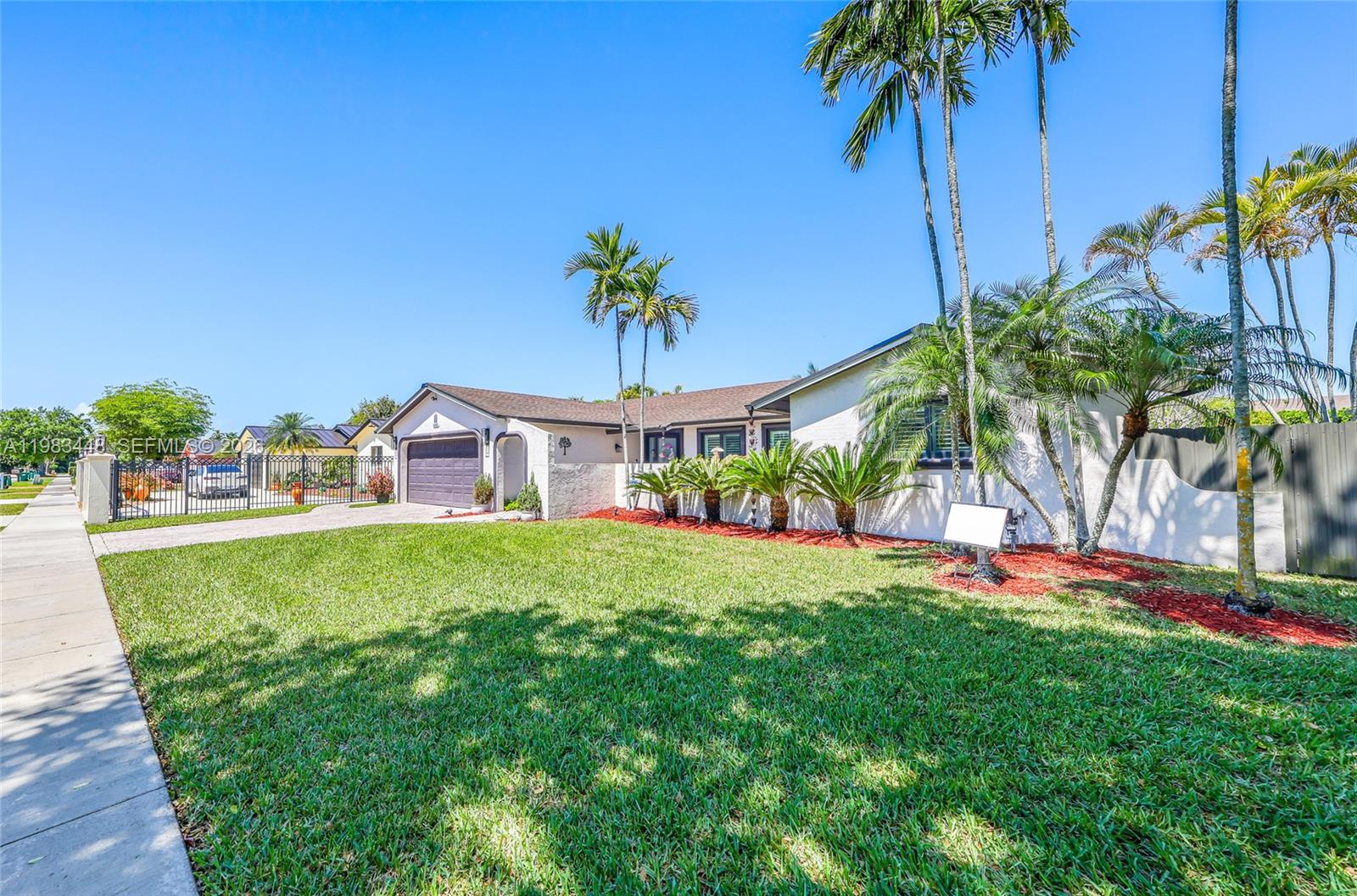 13951 Southwest 109th Street Miami, FL 33186 - Photo 3 of 34 a front view of a house with a garden
