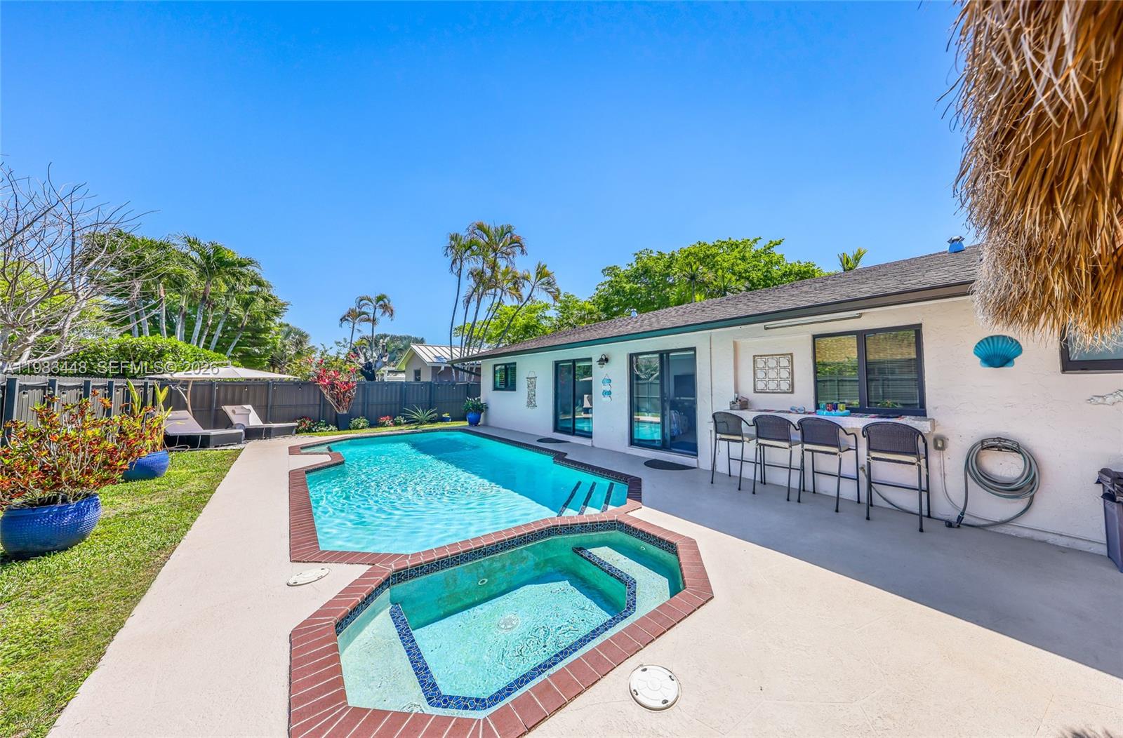 13951 Southwest 109th Street Miami, FL 33186 - Photo 32 of 34 swimming pool view with a seating space and a garden view