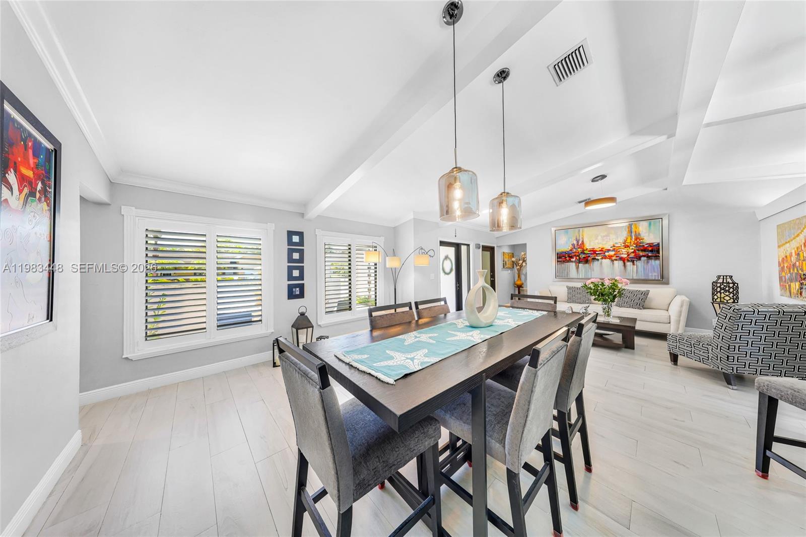 13951 Southwest 109th Street Miami, FL 33186 - Photo 6 of 34 a view of a dining room and livingroom with furniture wooden floor a chandelier