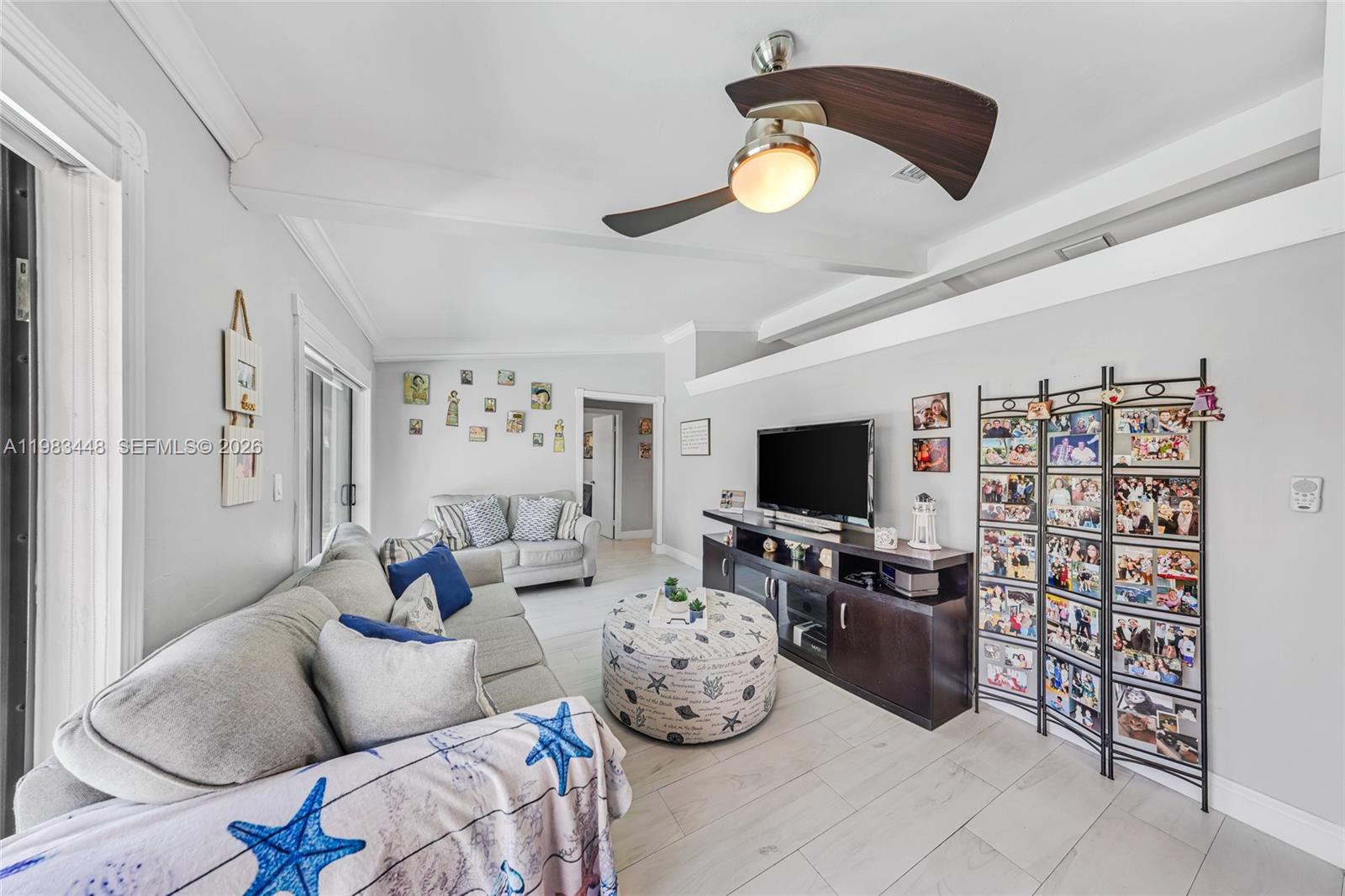 13951 Southwest 109th Street Miami, FL 33186 - Photo 9 of 34 a living room with furniture and a flat screen tv