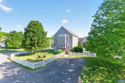 a view of a house with swimming pool and yard