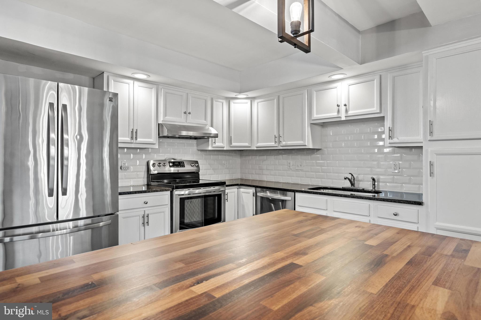 1796 Duffield Lane Alexandria, VA 22307 - Photo 10 of 42 a kitchen with granite countertop a refrigerator stove top oven and sink