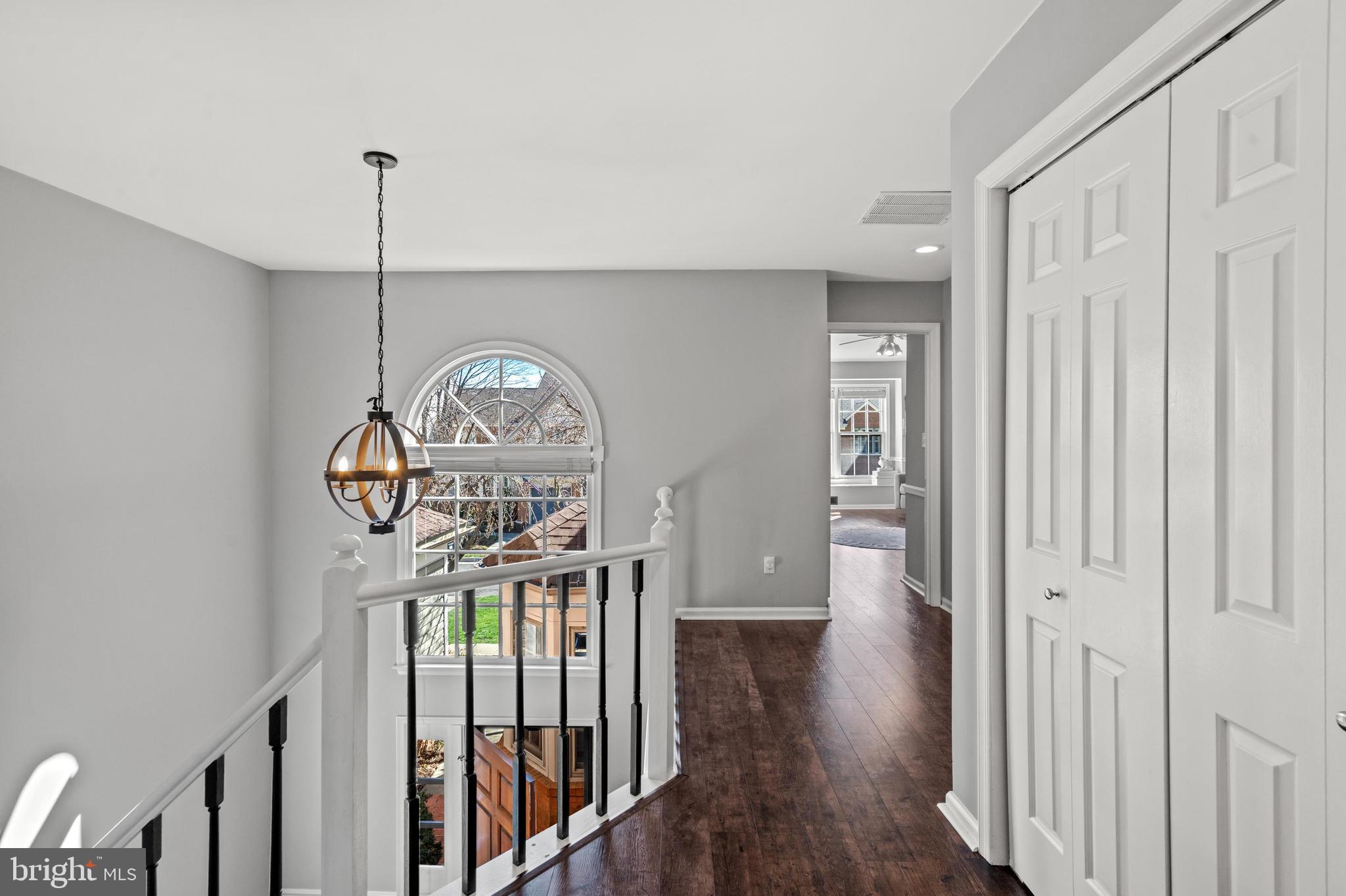 1796 Duffield Lane Alexandria, VA 22307 - Photo 18 of 42 a view of a hallway with wooden floor a chandelier