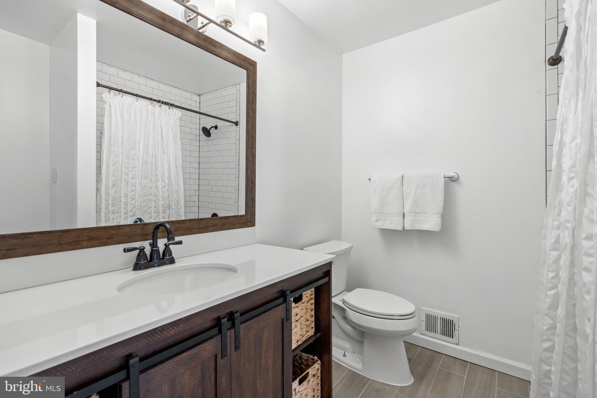 1796 Duffield Lane Alexandria, VA 22307 - Photo 29 of 42 a bathroom with a sink a toilet and mirror