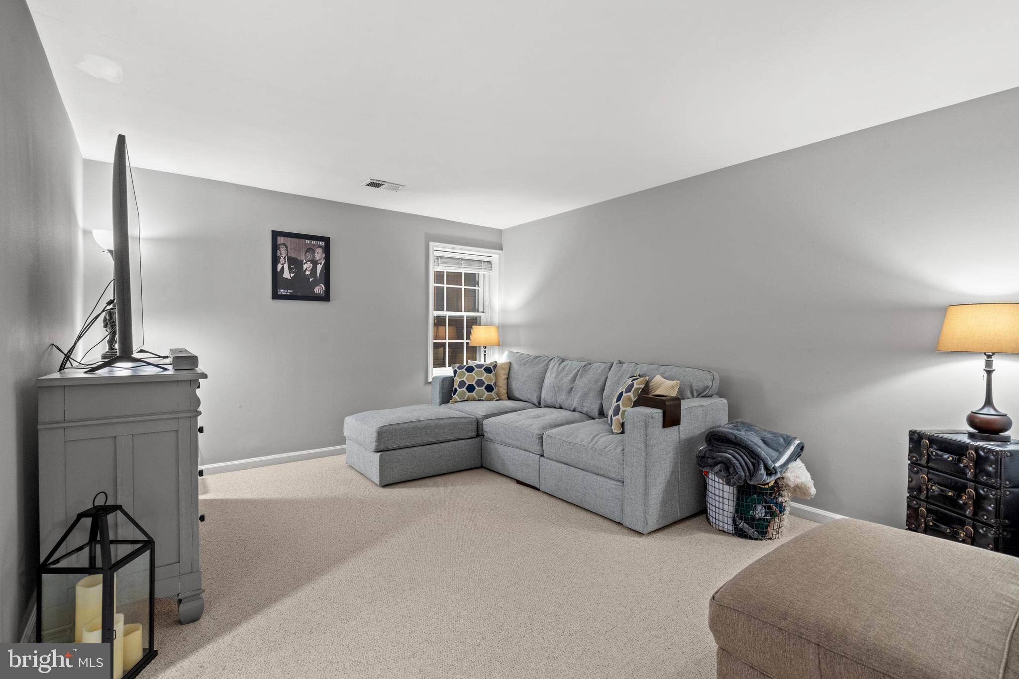 1796 Duffield Lane Alexandria, VA 22307 - Photo 31 of 42 a living room with furniture a lamp and a window