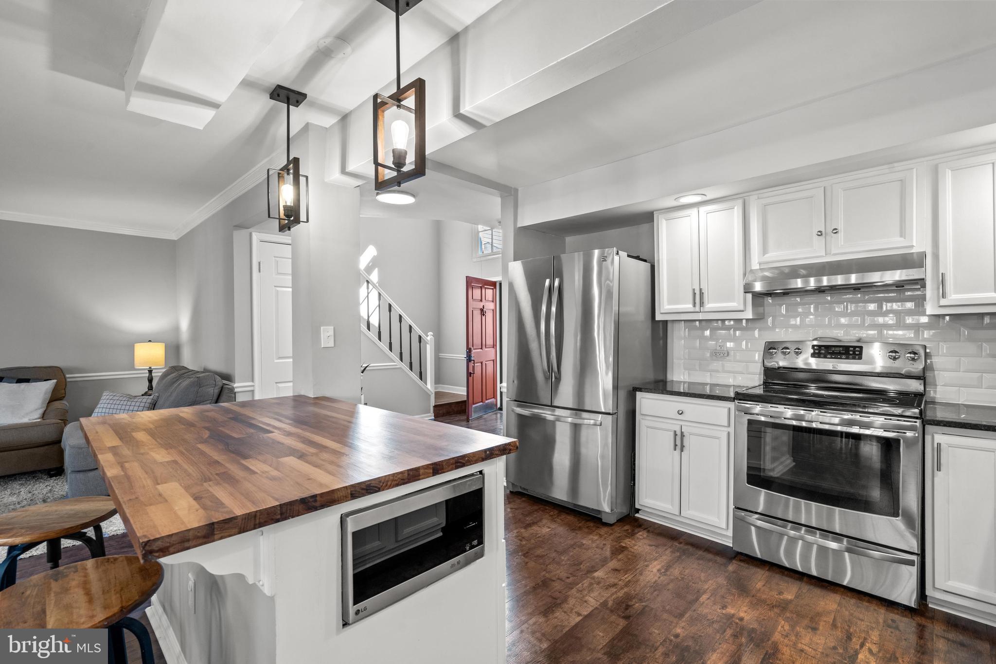 1796 Duffield Lane Alexandria, VA 22307 - Photo 3 of 42 a kitchen with stainless steel appliances granite countertop a stove and a refrigerator