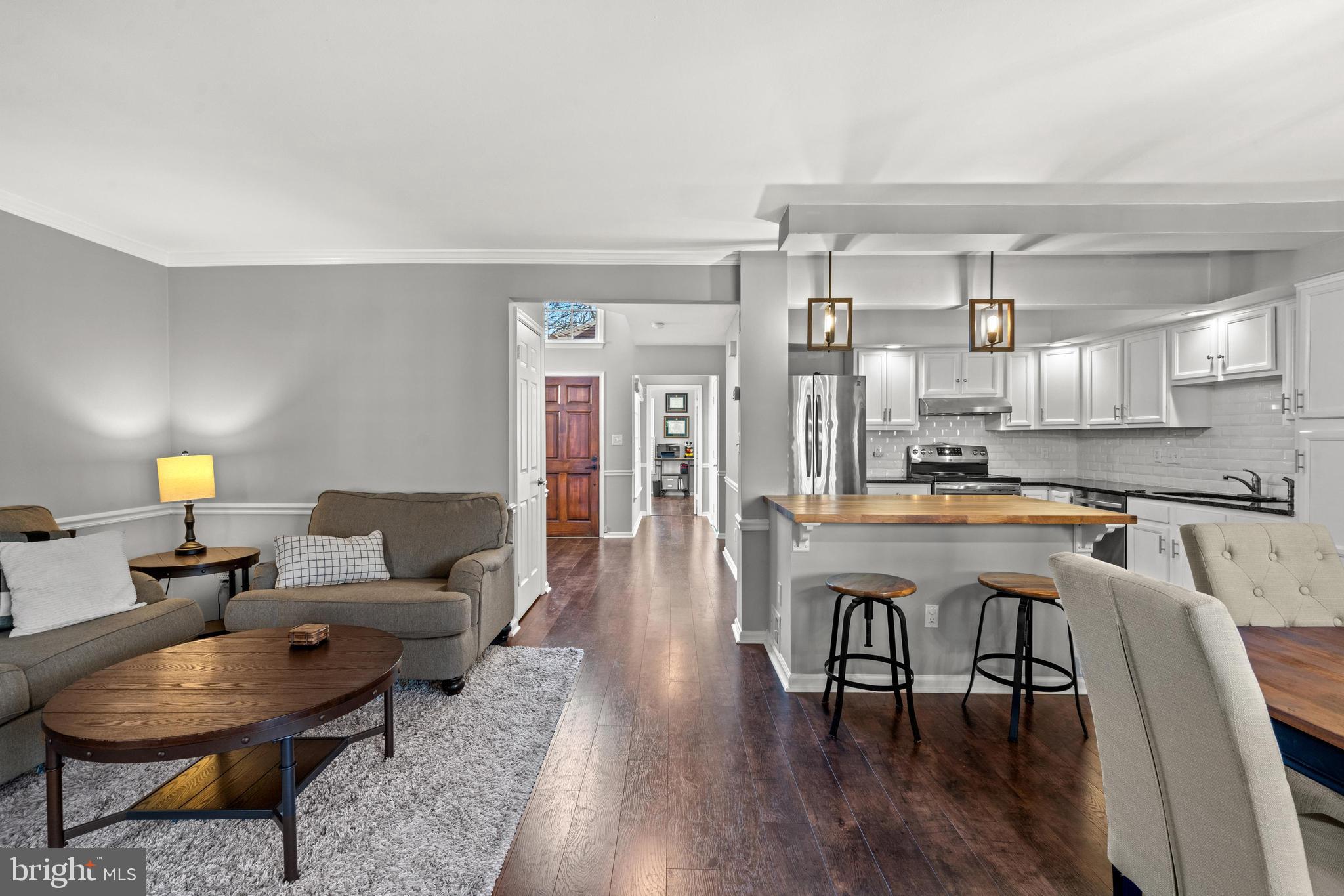 1796 Duffield Lane Alexandria, VA 22307 - Photo 41 of 42 a living room with stainless steel appliances kitchen island granite countertop furniture and wooden floor