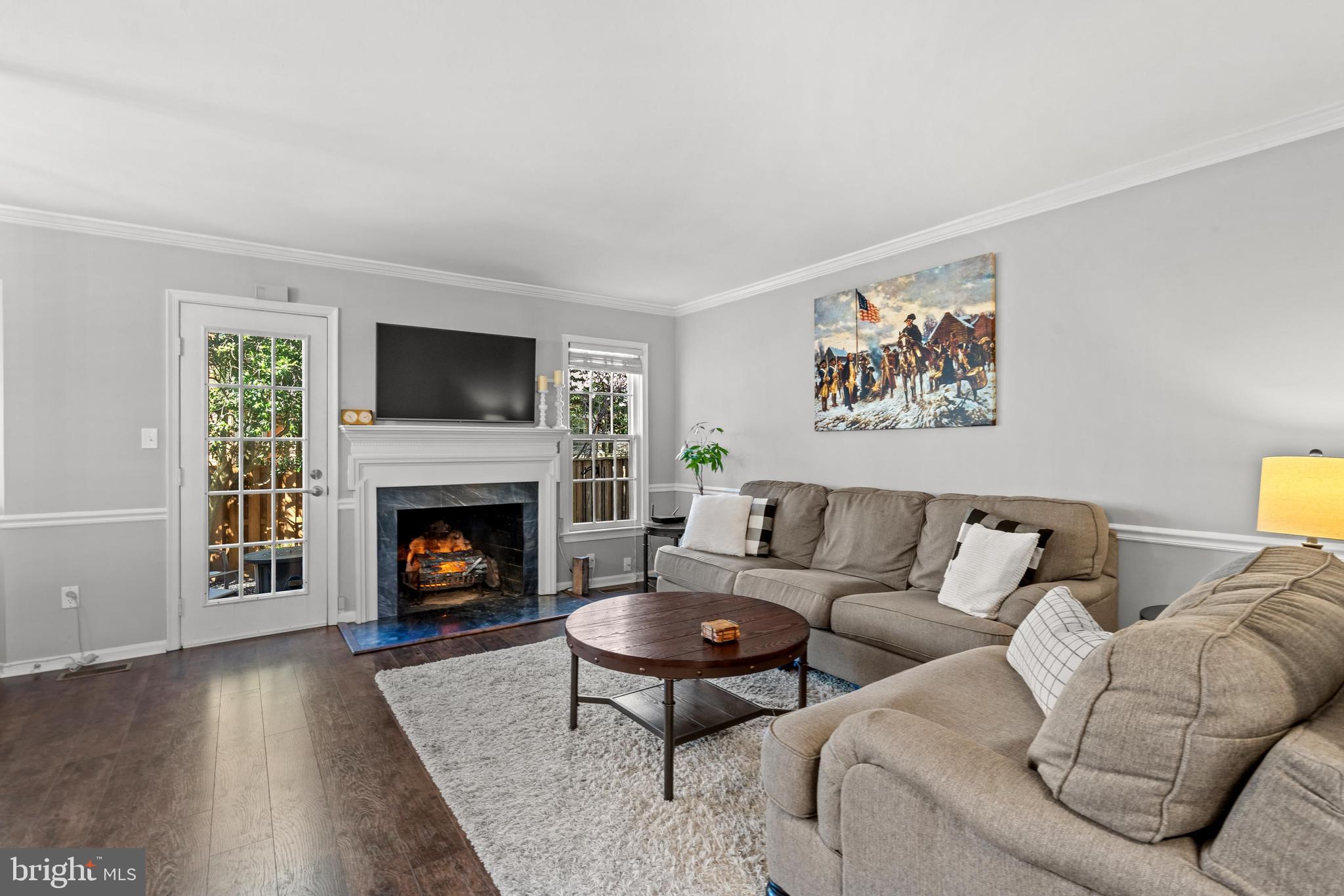 1796 Duffield Lane Alexandria, VA 22307 - Photo 7 of 42 a living room with furniture a flat screen tv and a fireplace