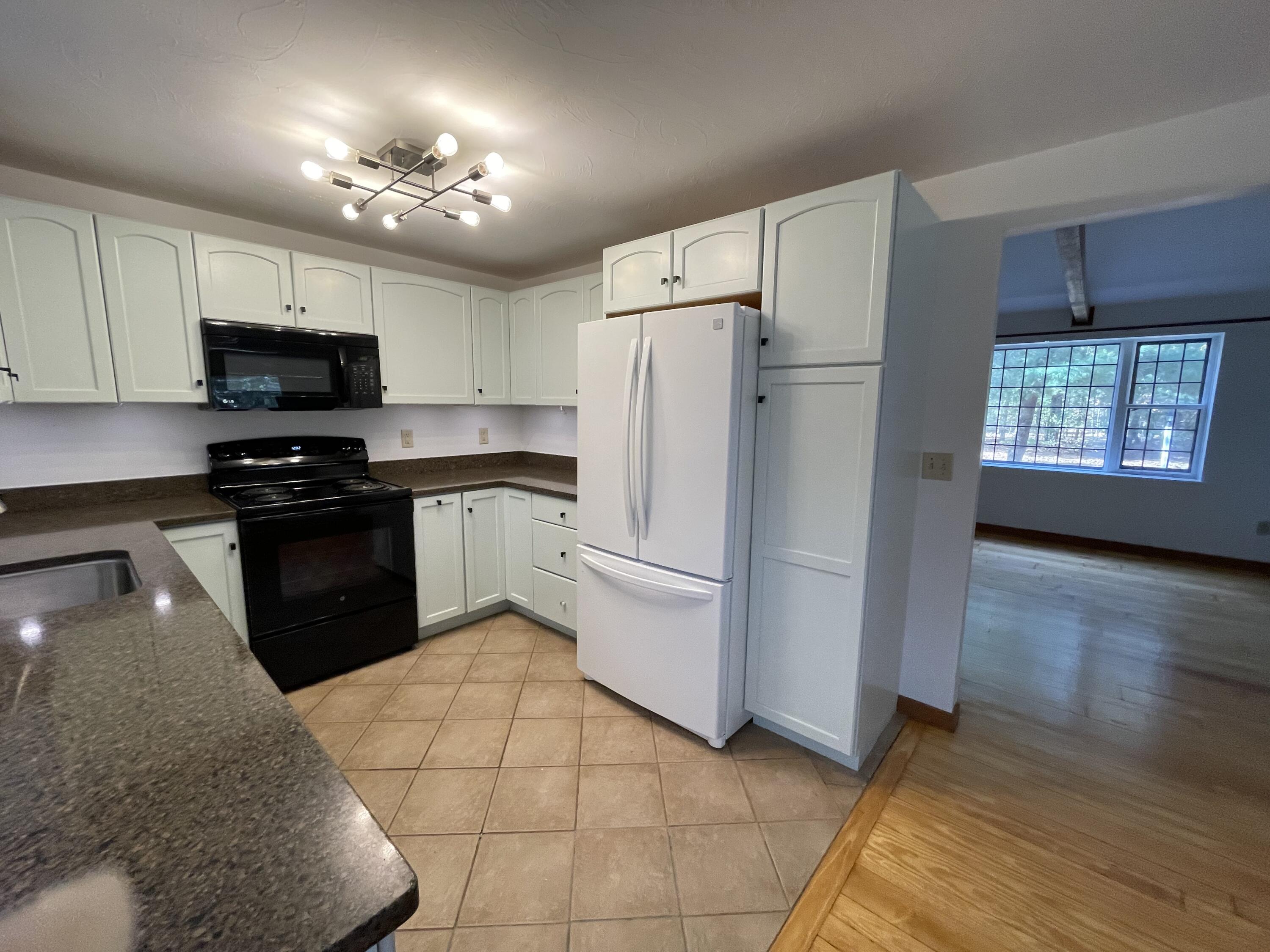 18 Sandy Valley Road Marstons Mills, MA 02648 - Photo 3 of 12 a kitchen with a refrigerator a stove top oven a sink and dishwasher