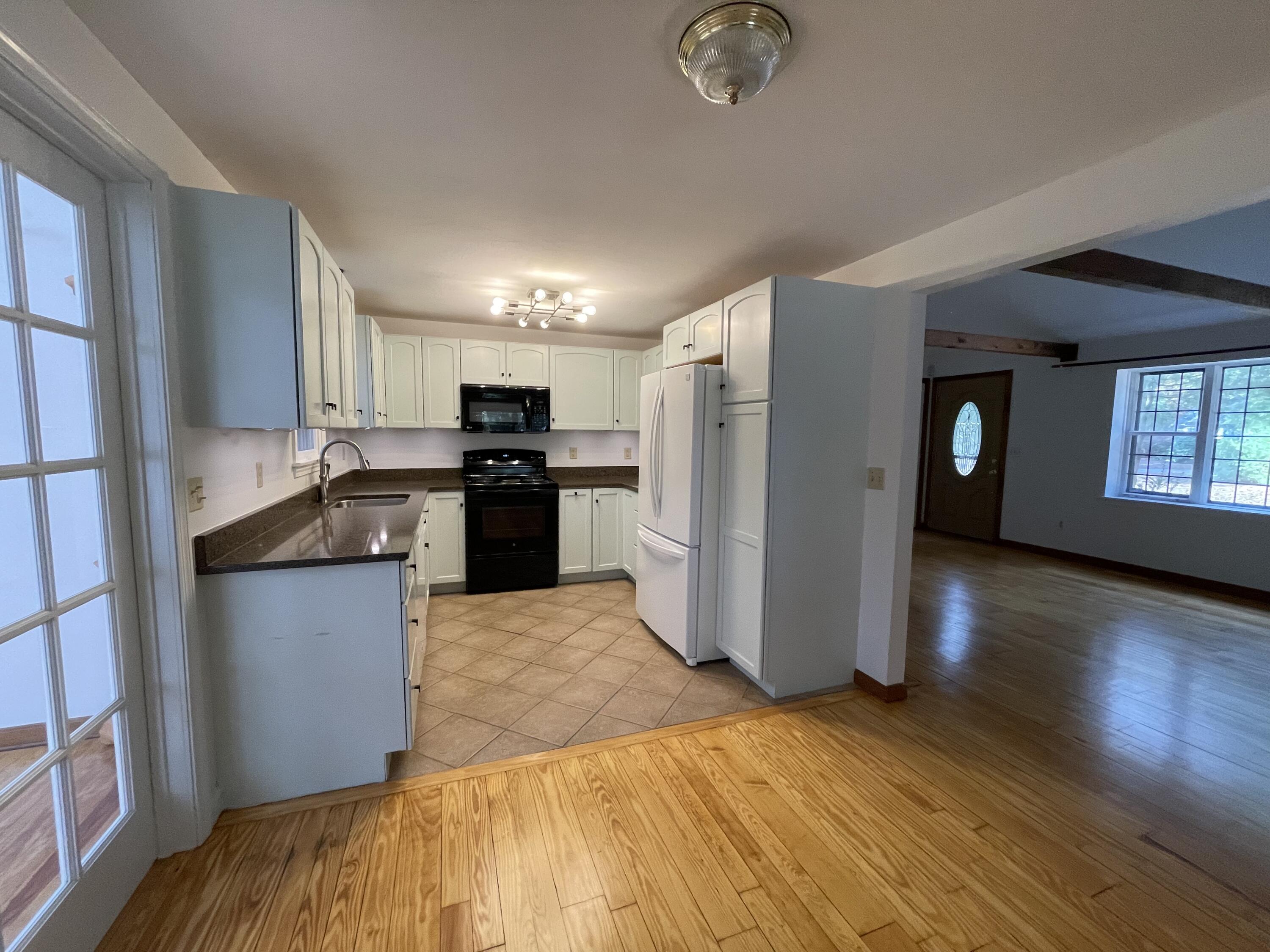 18 Sandy Valley Road Marstons Mills, MA 02648 - Photo 5 of 12 a kitchen with stainless steel appliances granite countertop a refrigerator a stove top oven a sink and dishwasher