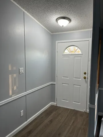 an empty room with closet and wooden floor