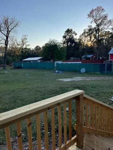 a view of a wooden deck and garden