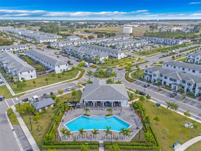an aerial view of residential houses with outdoor space and ocean view