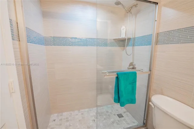 a bathroom with a green shower and toilet