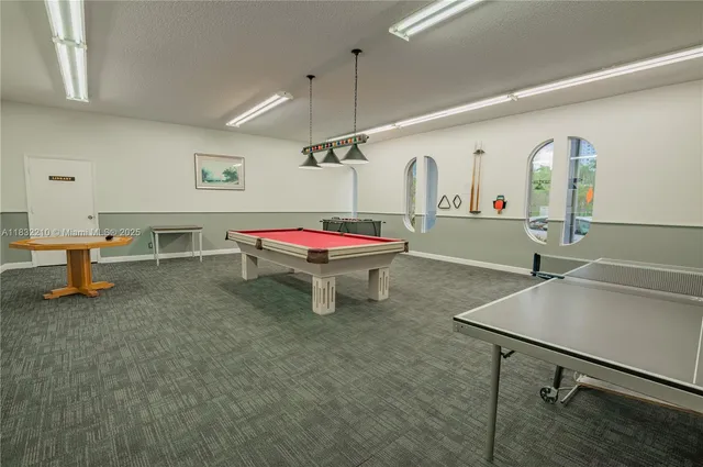 a room with table chairs and windows