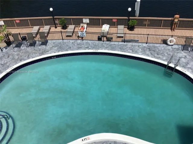 a view of a backyard with swimming pool