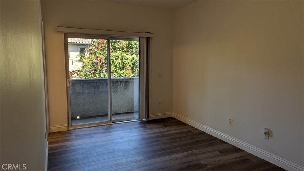 255 North Michigan Avenue, Unit 4 Pasadena, CA 91106 - Photo 27 of 39 a view of an empty room with wooden floor and a window