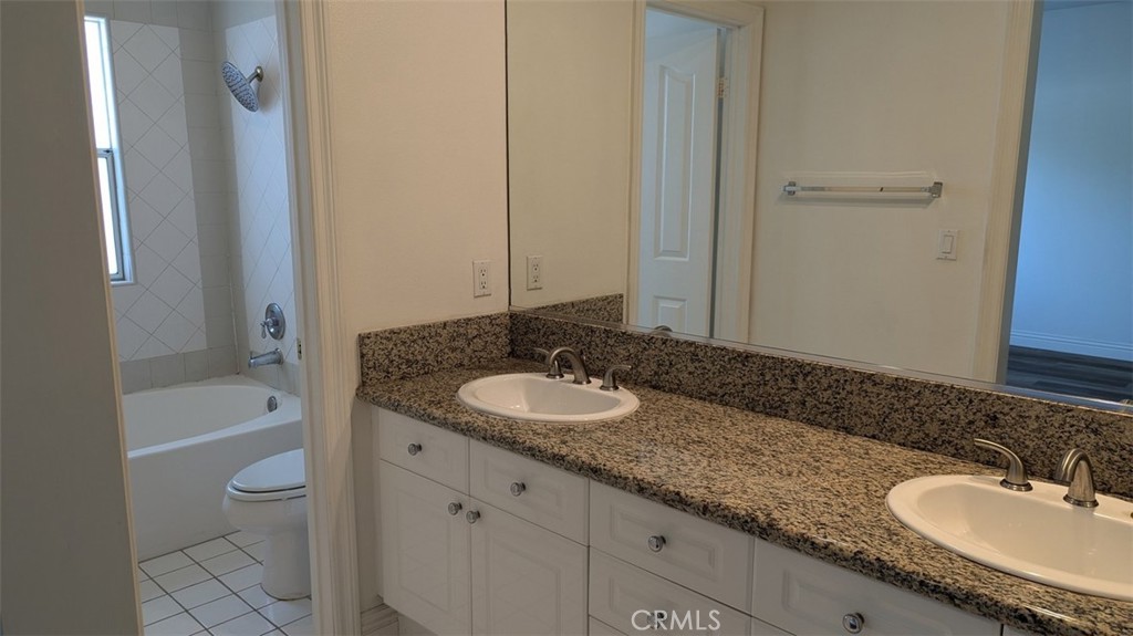 255 North Michigan Avenue, Unit 4 Pasadena, CA 91106 - Photo 35 of 39 a bathroom with a granite countertop sink and a mirror a bathtub