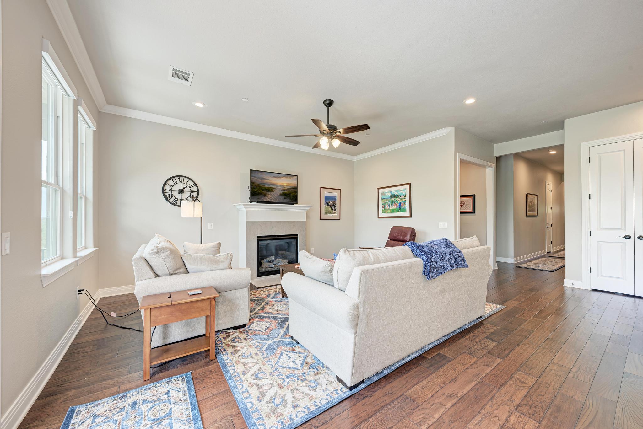 2601 North Quinlan Park Road, Unit 506 Austin, TX 78732 - Photo 9 of 39 Hardwood floors and a cozy fireplace create a warm and inviting atmosphere in this living room.