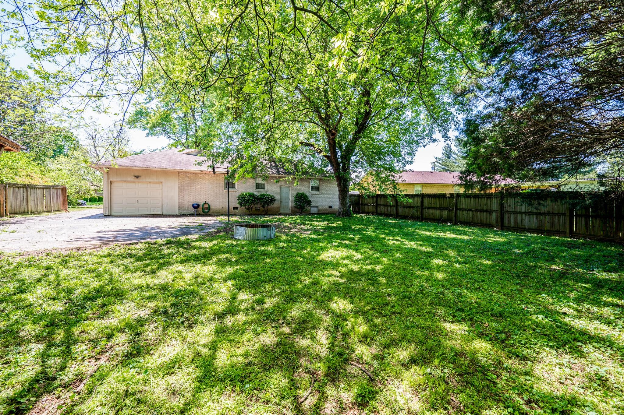 311 Santa Rosa Drive Old Hickory, TN 37138 - Photo 16 of 19 a view of a house with a big yard and a large tree