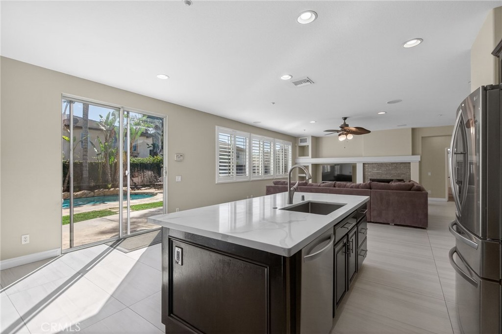 11552 Brookrun Court Riverside, CA 92505 - Photo 14 of 71 a kitchen with counter top space and stainless steel appliances