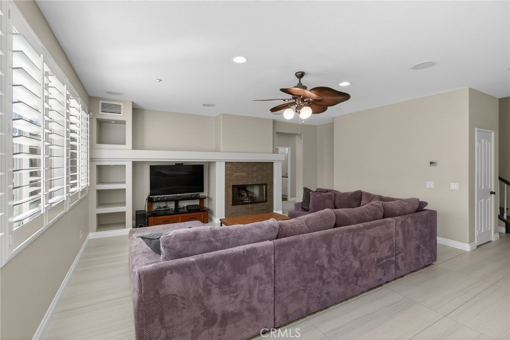 11552 Brookrun Court Riverside, CA 92505 - Photo 16 of 71 a living room with furniture a fireplace and a flat screen tv