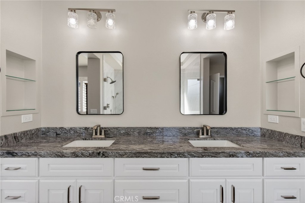 11552 Brookrun Court Riverside, CA 92505 - Photo 31 of 71 a bathroom with double vanity sinks and a mirror