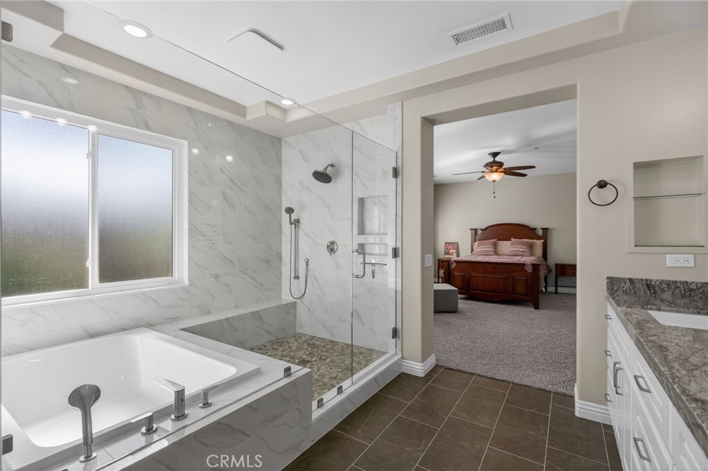 11552 Brookrun Court Riverside, CA 92505 - Photo 32 of 71 a spacious bathroom with a granite countertop tub sink and mirror