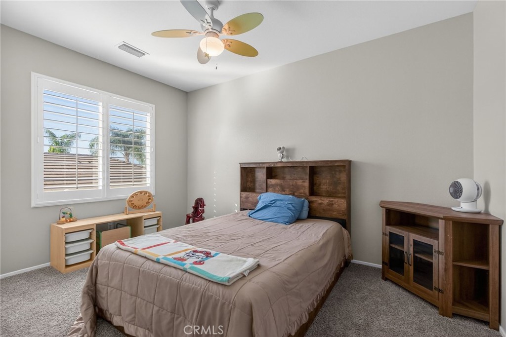 11552 Brookrun Court Riverside, CA 92505 - Photo 35 of 71 a bedroom with a bed and a chandelier