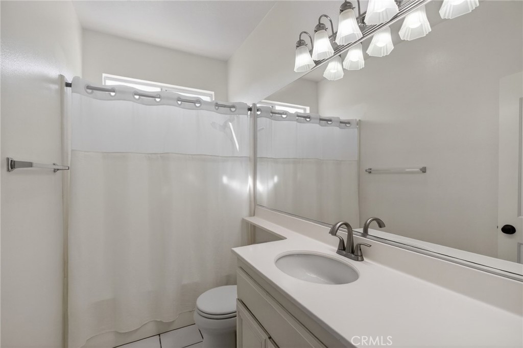 11552 Brookrun Court Riverside, CA 92505 - Photo 36 of 71 a bathroom with a sink a toilet and a mirror