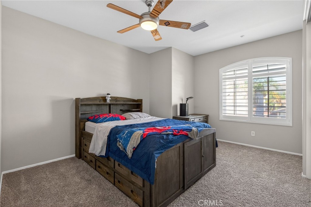 11552 Brookrun Court Riverside, CA 92505 - Photo 39 of 71 a bedroom with a bed and a chandelier