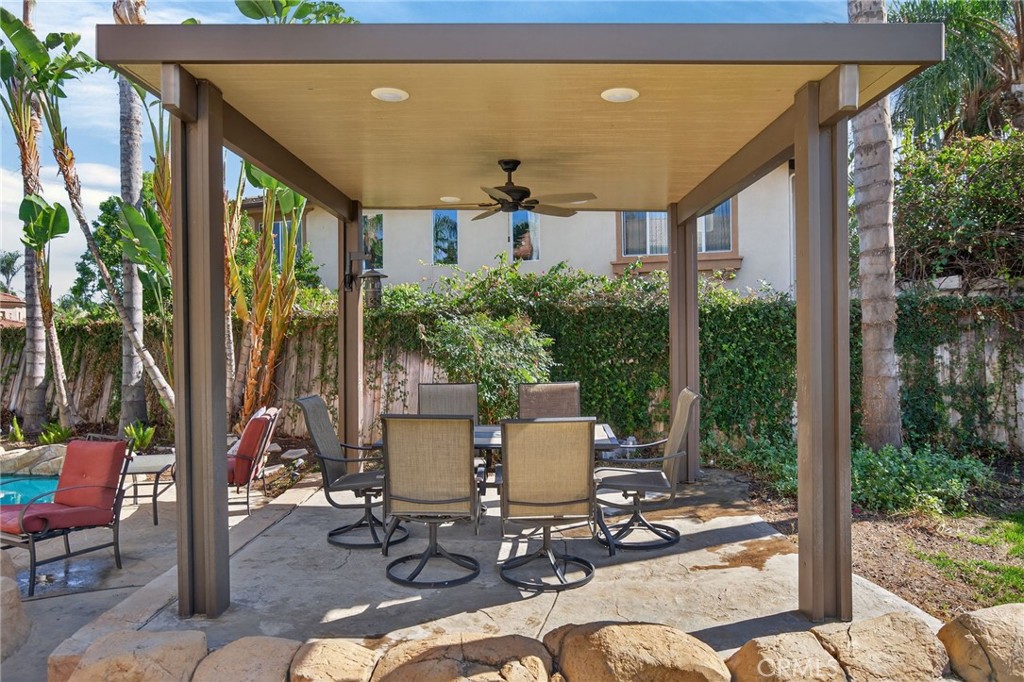 11552 Brookrun Court Riverside, CA 92505 - Photo 49 of 71 a view of a patio with table and chairs potted plants and palm tree
