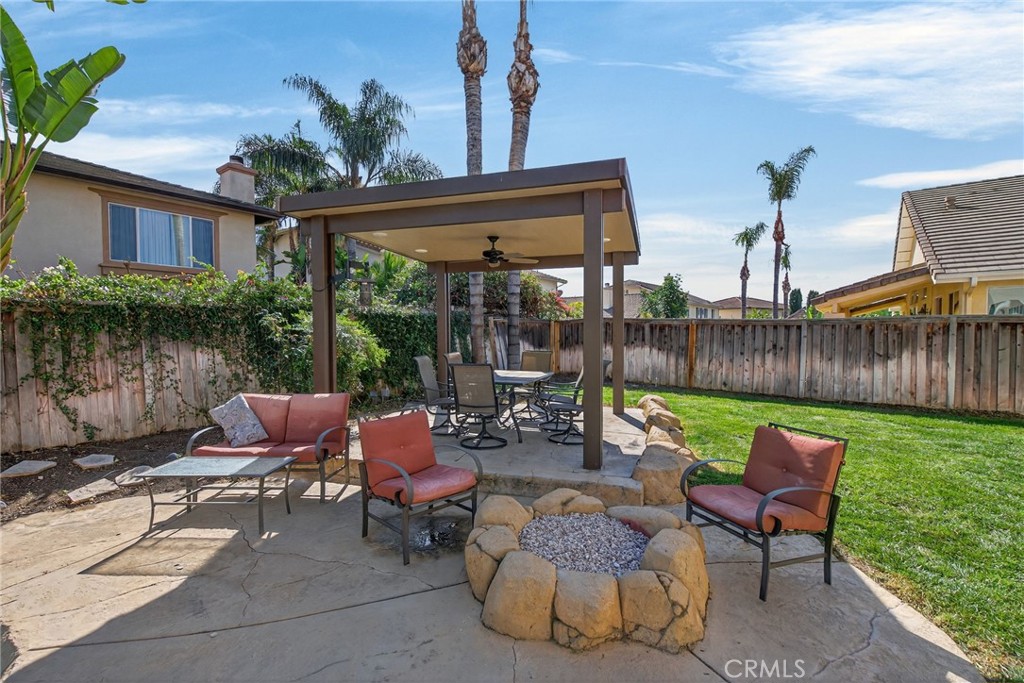 11552 Brookrun Court Riverside, CA 92505 - Photo 50 of 71 a view of a patio with couches chairs potted plants and a palm tree
