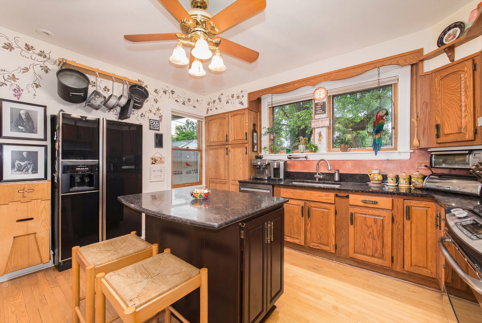 1605 South Fairview Avenue Park Ridge, IL 60068 - Photo 7 of 31 a kitchen with stainless steel appliances granite countertop a stove a refrigerator a sink dishwasher with a dining table and chairs with wooden floor