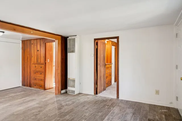 an empty room with closet and a window