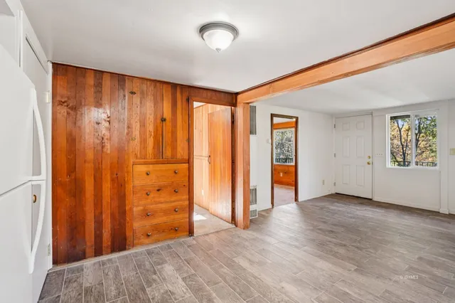 a view of a room with wooden floor