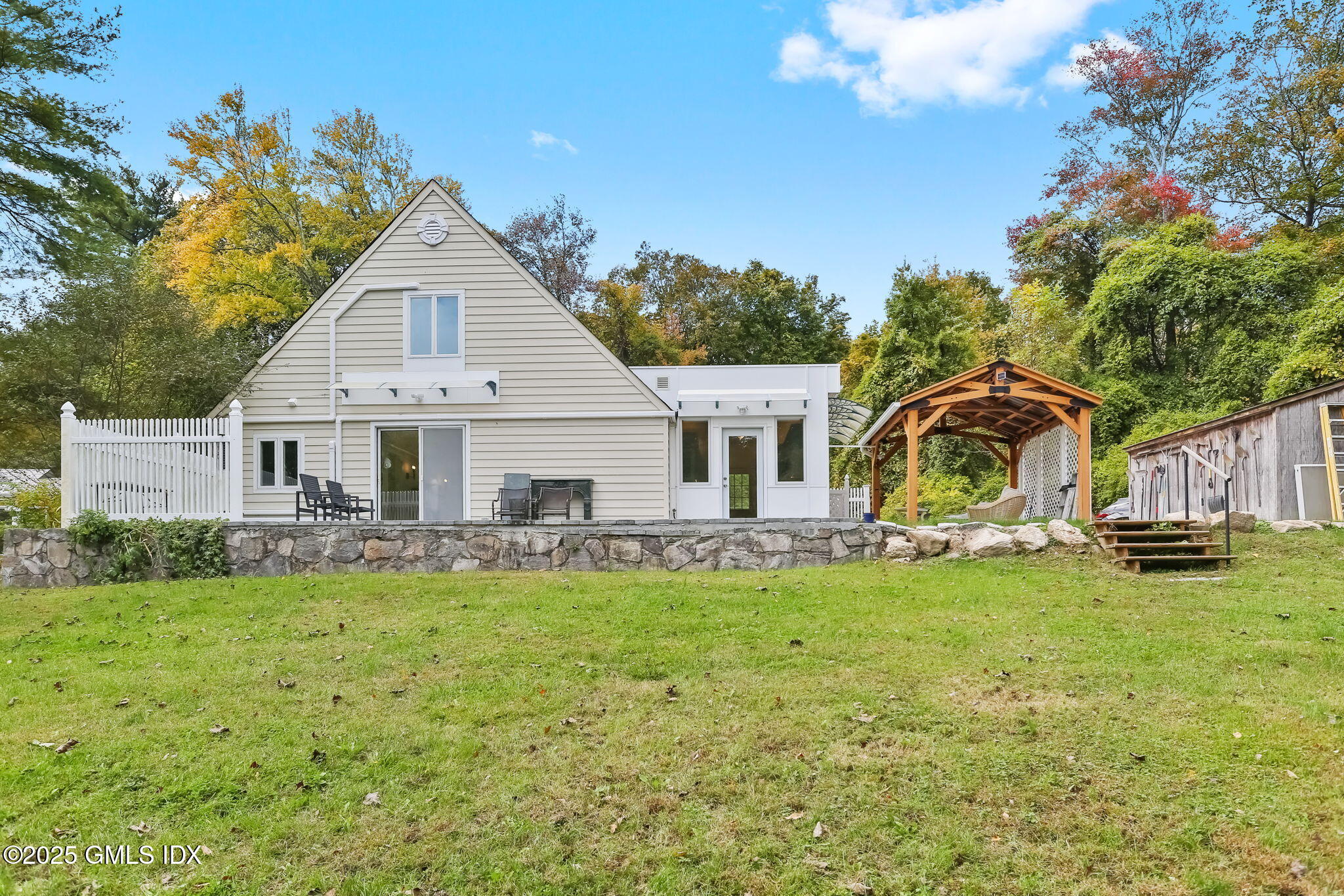 527 Stanwich Road, Unit COTTAGE Greenwich, CT 06831 - Photo 15 of 18 a aerial view of a house with swimming pool and sitting area