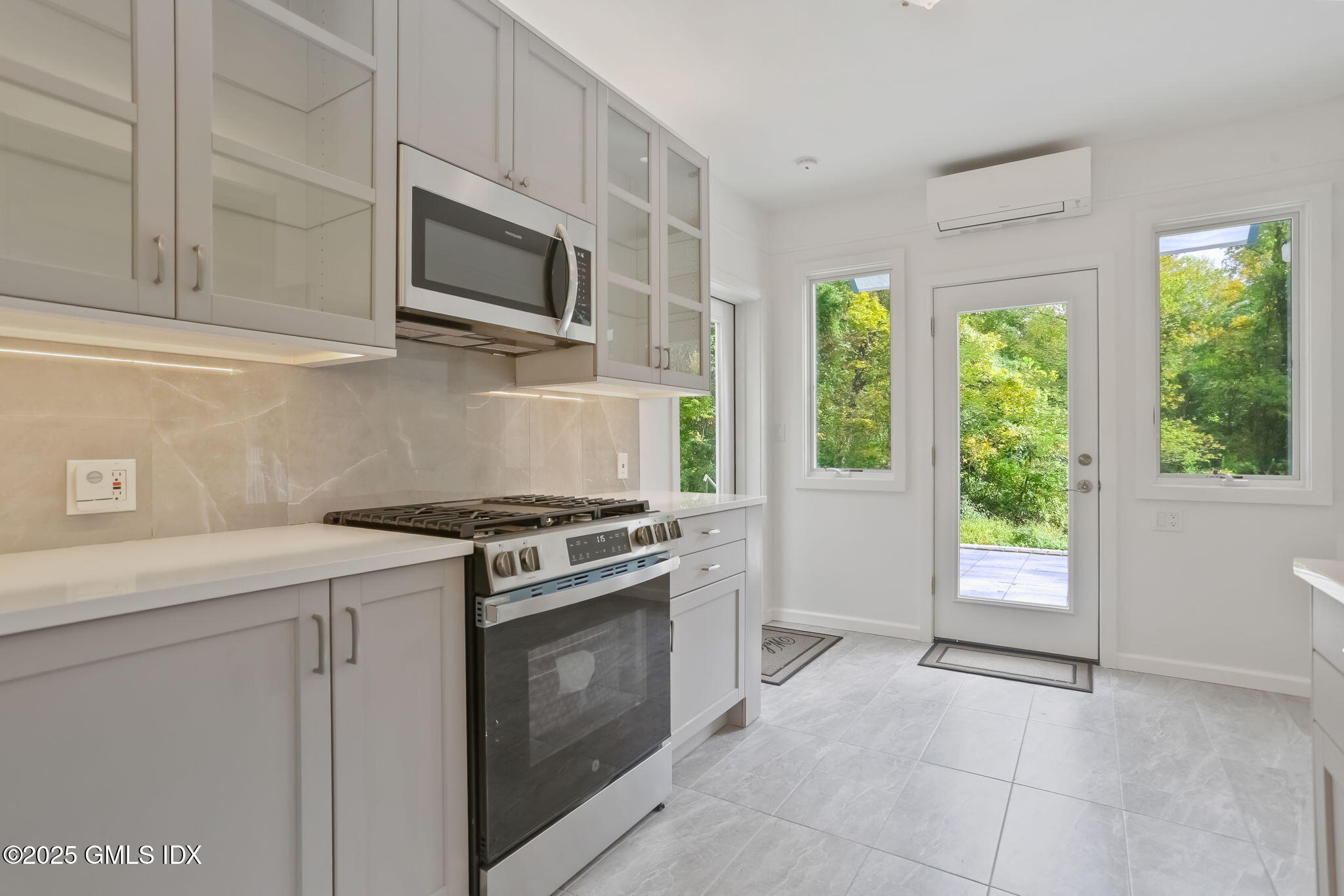 527 Stanwich Road, Unit COTTAGE Greenwich, CT 06831 - Photo 4 of 18 a kitchen with a stove a sink and a microwave