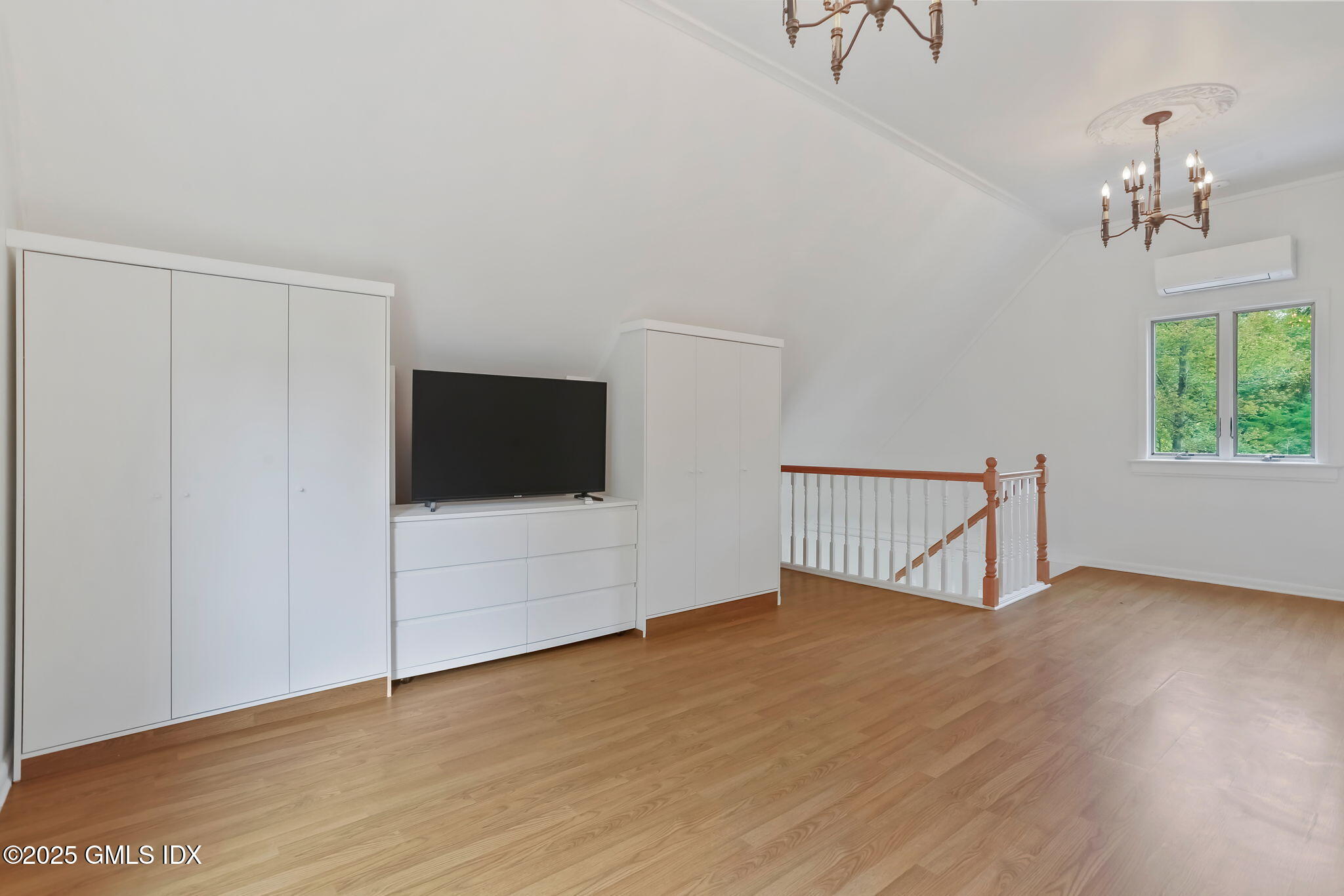 527 Stanwich Road, Unit COTTAGE Greenwich, CT 06831 - Photo 9 of 18 a view of an empty room with wooden floor and a window