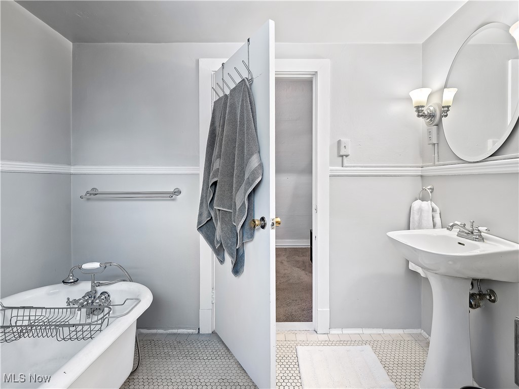 2842 Lee Road Cleveland, OH 44120 - Photo 23 of 44 Full bath featuring a freestanding tub and baseboards