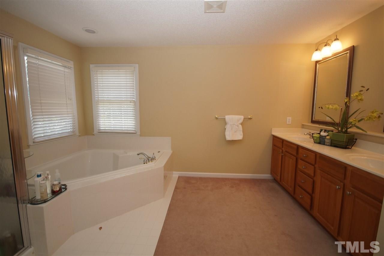 7908 Broad Street Raleigh, NC 27613 - Photo 14 of 24 a spacious bathroom with a tub sink and mirror