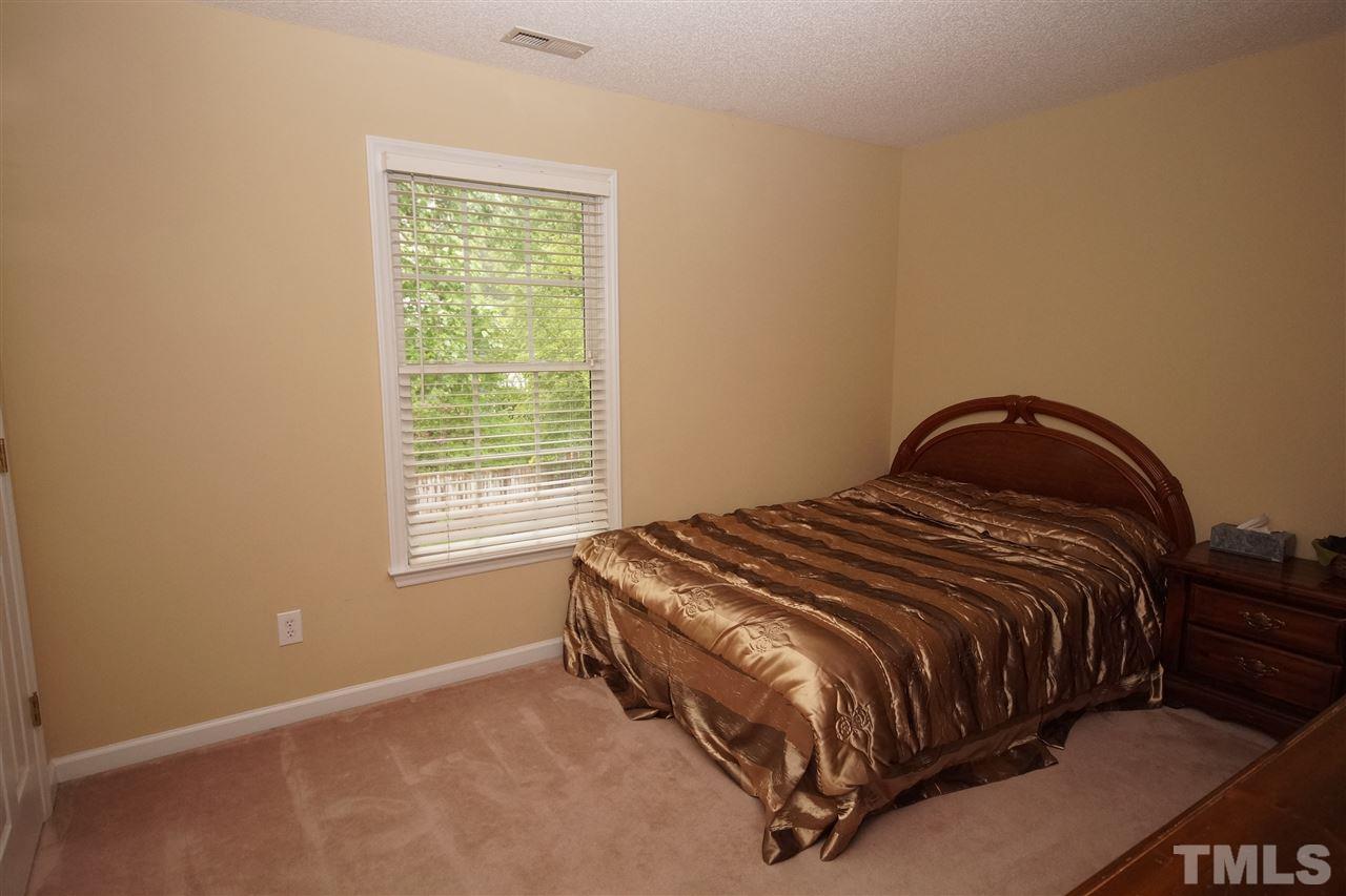 7908 Broad Street Raleigh, NC 27613 - Photo 16 of 24 a bedroom with a bed and window